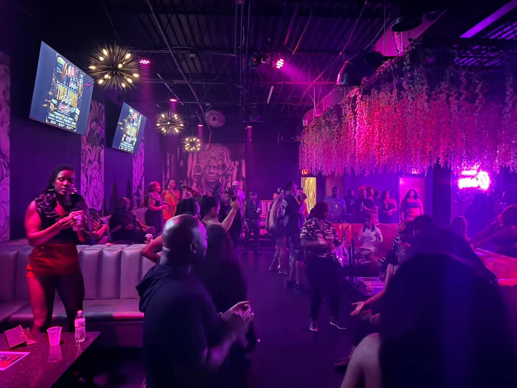 Guests enjoying the lounge floor under purple lighting